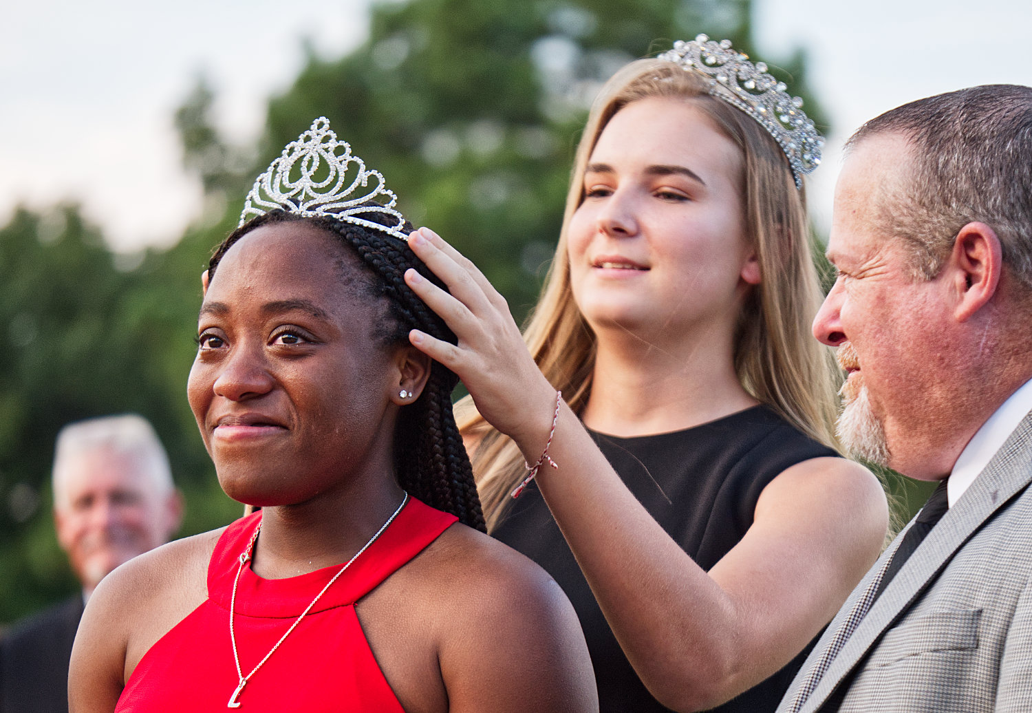 Lovely Wright is crowned Minoela 2019 homecoming queen by last year’s queen, Lena Hughes, as Wright’s escort, youth Pastor Kendall Banks looks on prior to Friday’s football game with Farmersville (which the Yellowjackets won handily).